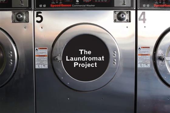 A washing machine with the words 'The Laundromat Project' over the top