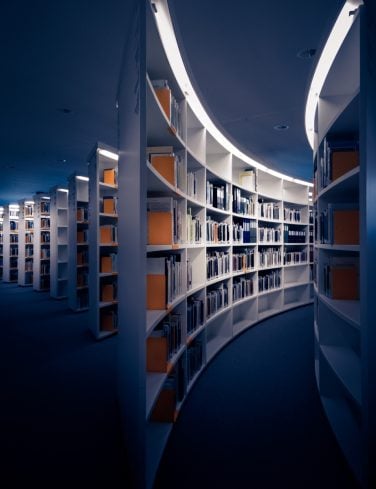 An empty library with tall white shelves