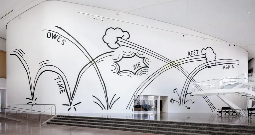 A large wall in a public building with a graphic which reads 'time owes me rest again'