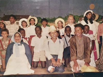 An old photograph of a group of school children performing a play