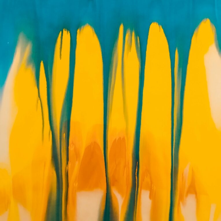 blue-green background with bright, petal-like streaks of yellow and orange