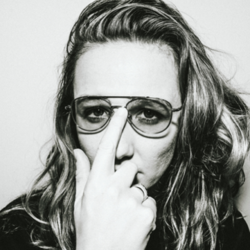 Black and white headshot of Zoe Riordàin wearung sunglasses