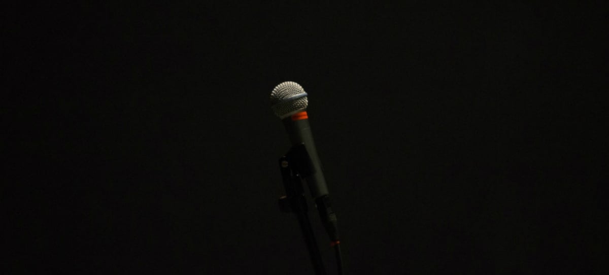 A single microphone with a dark background
