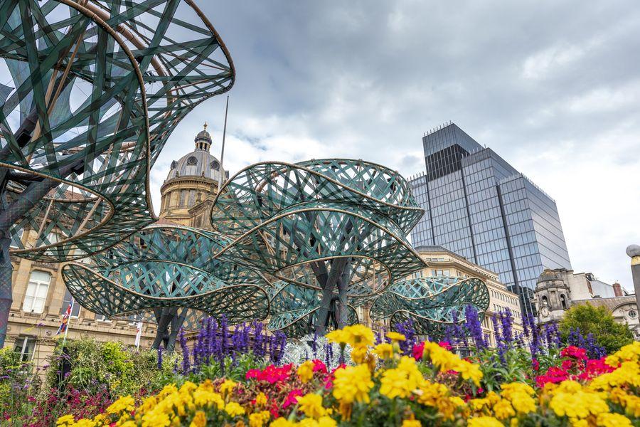 An urban garden with large conceptual sculptures