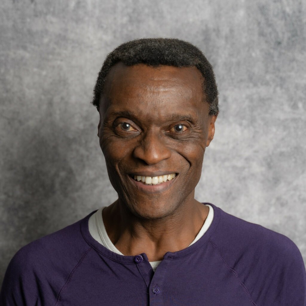 Headshot of John Malcolm, he is smiling 