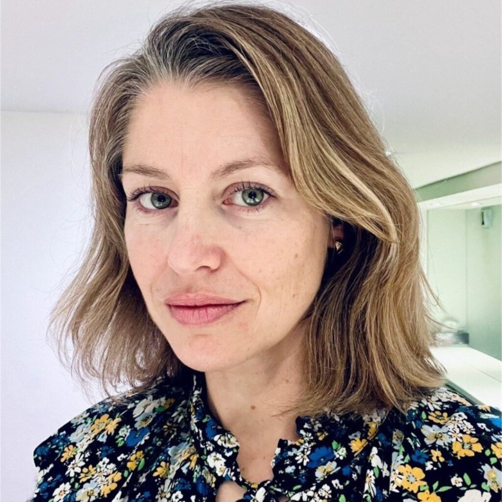 Headshot of Lilli Geissendorfer, she has short hair and is wearing a floral shirt
