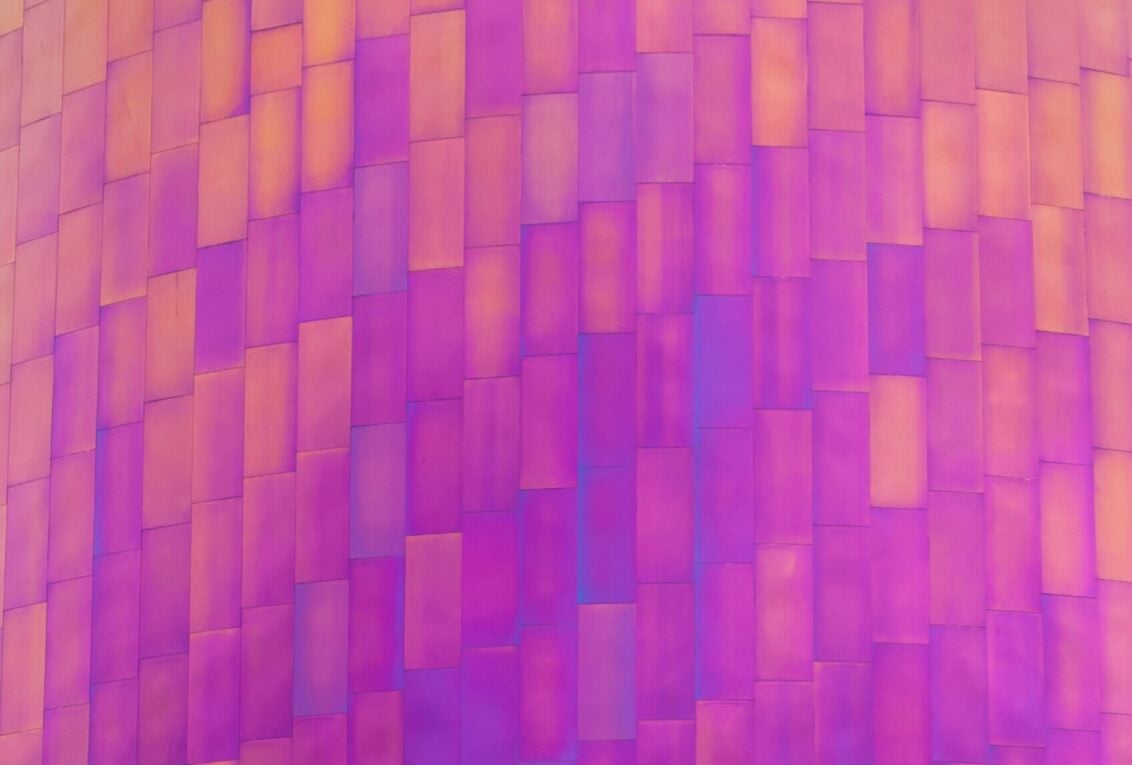 An abstract picture of architecture with a pink filter