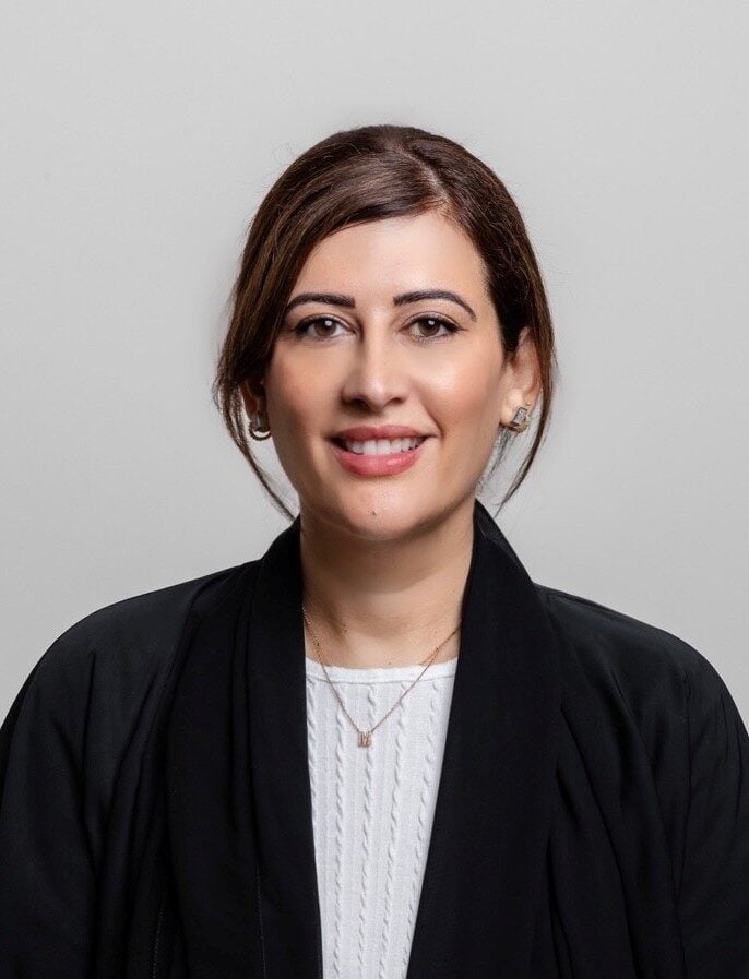 A smart portrait of Manal smiling looking at the camera