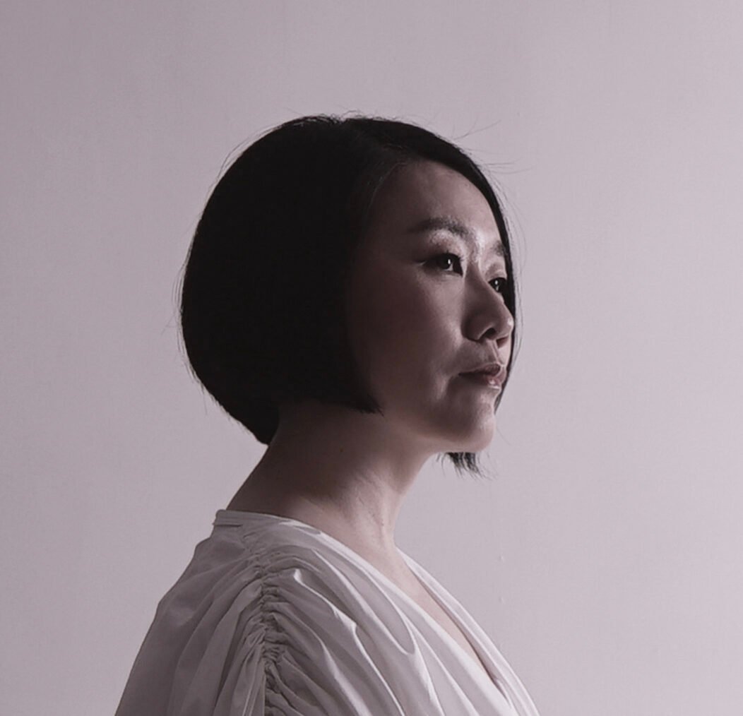 A formal portrait of Vicky looking thoughtfully into the distance