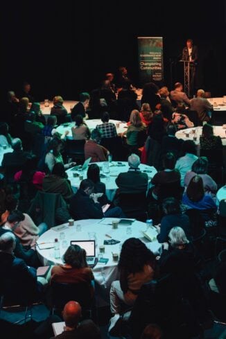 A group of people at Governance Now watching a keynote.