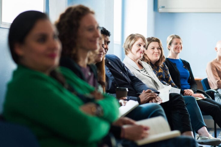 Group of people sat down in workshop
